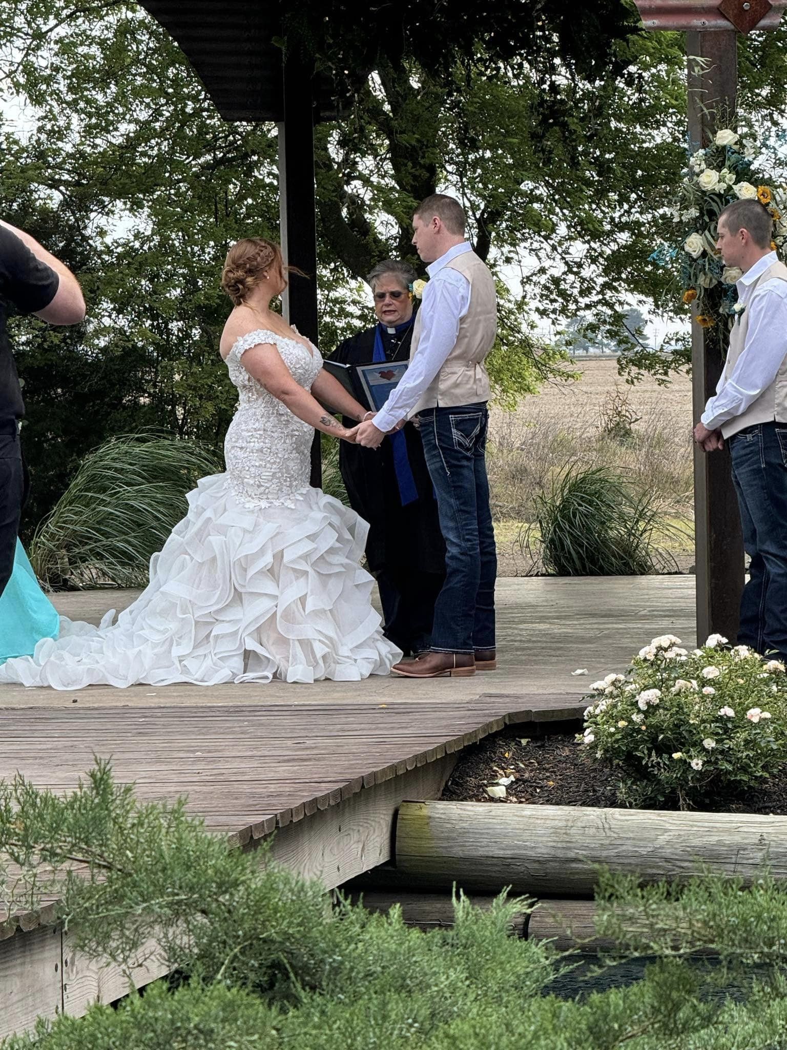 couple holding hands at ceremony