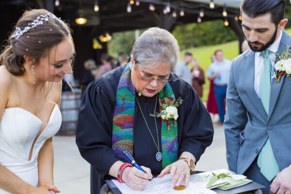 Officiant Jen signing marriage license