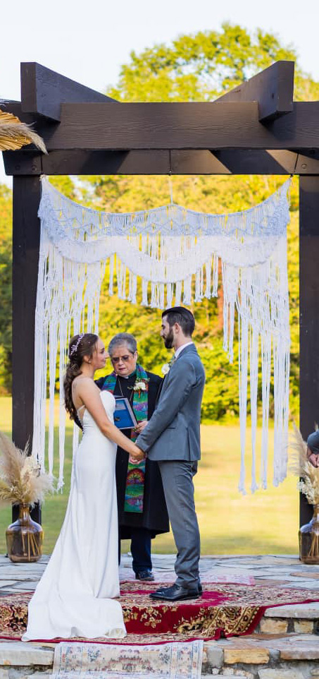 couple holding hands at ceremony