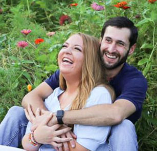 couple laughing in flower field